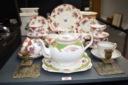 A Aynsley fine bone china part tea service, decorated with floral patterns on an ice white