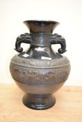 An attractive Chinese cast-bronze vase, of archaic design with elephant form handles and bands of