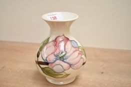 A Moorcroft pottery Hibiscus pattern vase of bulbous form, decorated with pink foliage on a glaze