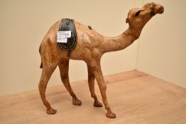 A Liberty's of London style Camel sculpture having glass eyes and aged leather on hand carved