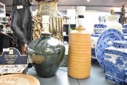 A stoneware table lamp having textured patterns on a sand coloured ground, h26cm, sold together with