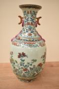 A Chinese Qing Jiaqing type Famille Rose porcelain vase of bottle form, having two ear handles,