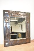 A late 19th/early 20th century Art Nouveau design copper framed mirror, with bevelled plate, the