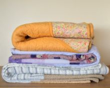 Three mid-to-late 20th century heavyweight quilted blankets. A quilted coverlet in taupe, having a