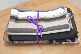 A collection of vintage British fabrics, comprising a 2m bolt of Pelham charcoal herringbone wool,