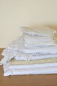 A quantity of crochet tablecloths and home linens, including white cotton and crochet examples,