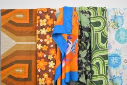 A quantity of vintage curtains and fabric, mainly 1960's graphic prints in the typical oranges and