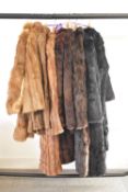 Eight antique and vintage British-made fur coats and a fur cape, in a range of shades and hides,