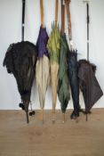 Six antique and vintage silk parasols, each showcasing a different style of craved, turned or