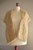 A vintage blonde mink shawl, having a wide collar and taupe satin lining.