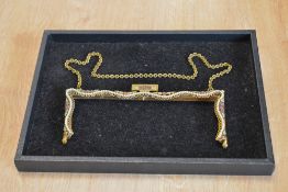 A vintage handbag frame, in brass with a wavy row of faux pearls, having floral detailing with