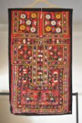 A vintage wall hanging example of Shisha embroidery, characterised by small circular mirrors