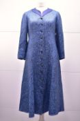 Six pieces of wedding guest attire, comprising two dress coats and four hats/fascinators. A mid to