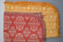 Two 1960s-70s woven coverlets with floral decoration, curved end corners and tasselled fringing,