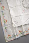 Two pieces of hand embroidered and cross-stitched tablecloths, featuring beautiful examples of