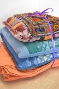 Three vintage woolen scatter cushions, including two blues and green woven examples and a warm toned