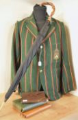 A collection of antique and vintage men's travel cases, accessories and a collegiate blazer. An