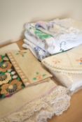 Eight peices of mid-century vintage home textiles, including six hand embroidered tablecloths or