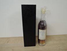 A bottle of 1955 Armagnac Baron de Lustrac, 40 % vol, 70cl, reveres label L 552701105