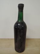 A bottle of 1963 Taylor's Vintage Port, no labels present, bottom of bottle numbered 299