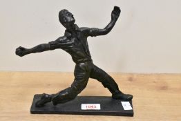 A limited edition cast resin figure of a cricketer bowling, number 7/75 by Jack Flower 20cm