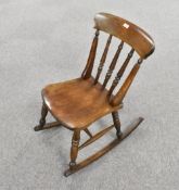 A modern reproduction spindle-back rocking chair, of traditional design, seat height 42cm