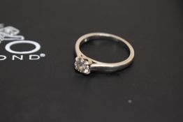 A white metal (thought to be platinum) diamond set solitaire ring, the brilliant cut diamond