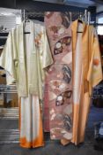 Two attractive Japanese Kimonos, each decorated with blossoms and sold along with a decorative Obi