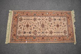 A European machine made rug, of Zeigler type design with tasselled ends 158cm x 82cm