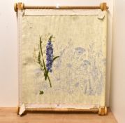 A large modern needlework/tapestry frame with incomplete floral design needlework panel attached,