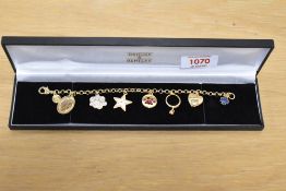 A decorative Brooks & Bentley gilt metal charm bracelet, the circular links suspending six