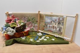 Two tapestry frames with uncompleted woolworks, to include an assortment of wool