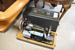 A vintage Singer sewing machine , with electric motor