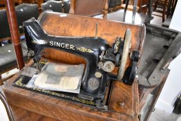 A Victorian Singer sewing machine (hand crank) in domed case
