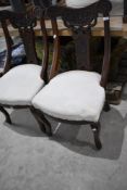 A set of four Victorian salon/dining chairs having overstuffed seats, upholstery project
