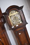 An early 20th Century oak grandmother clock having brass Roman numeral dial, height approx. 171cm