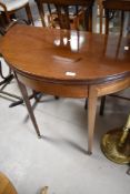 A 19th Century mahogany fold over demi lune tea table