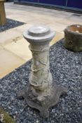 A concrete garden column, having vine style decoration
