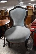 A Victorian mahogany framed nursing chair having later baby blue dralon upholstery