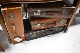 Four vintage suitcases including leather