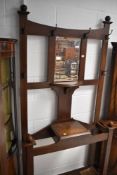 An early 20th Century oak hall stand, having Arts and Crafts style coat hooks, height approx. 200cm,