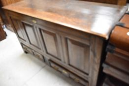An 18th century and later oak mule chest or kist having four panels and twin drawers to base, width
