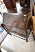 An early 20th Century oak bureau , having drawers to base , with barley twist legs, width approx.
