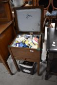 An early 20th Century oak sewing box and contents plus extra haberdashery items