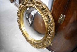 A gilt plaster convex wall mirror, diameter approx. 58cm