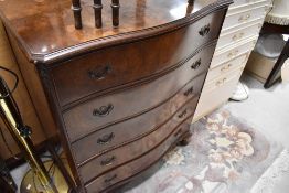 A reproduction period style chest of five long drawers , having serpentine front