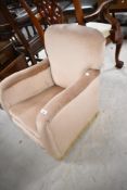 An early 20th Century Howard style childs easy chair having beige dralon upholstery, width approx.