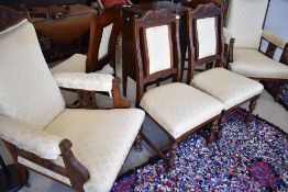 A Victorian mahogany framed salon suite comprising four dining chairs and two easy chairs, with