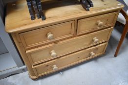 A modern pine low chest of two over two drawers, dimensions approx. W92 H66 D45cm