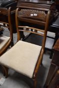 A set of four Regency mahogany railback dining chairs having later upholstered drop in seats